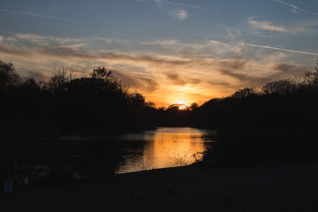 Sun setting at spring over a lake
