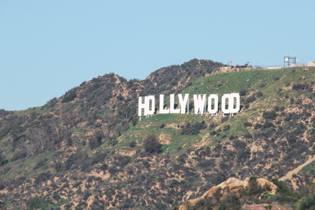 A photograph of the Hollwood sign set on the side of a hill.