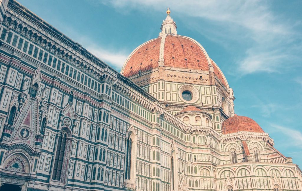 An image of Brunelleschi's Dome on Florence Cathedral against a blue sky. 